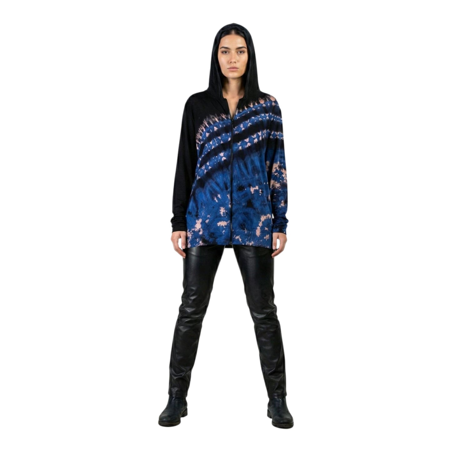 Woman wearing a blue and black patterned top with black pants on a white background