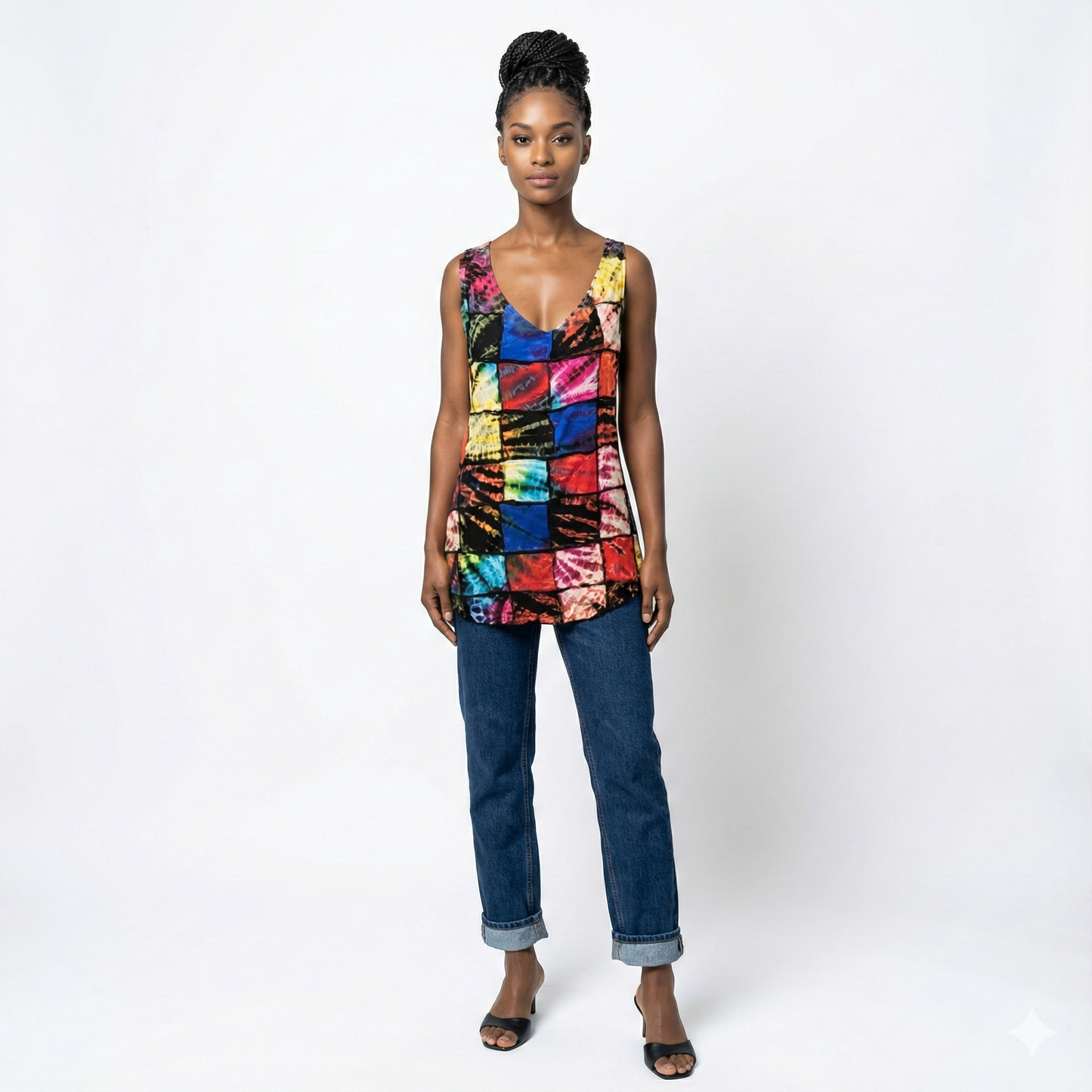 Woman wearing a colorful sleeveless top and jeans on a white background