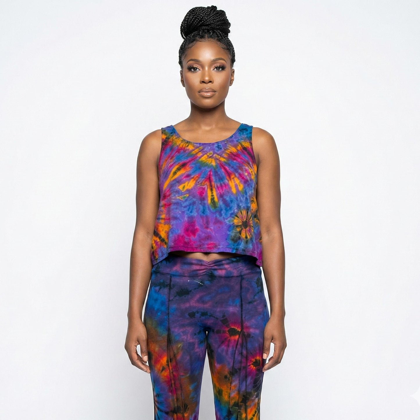 Woman wearing a colorful tie-dye outfit on a white background