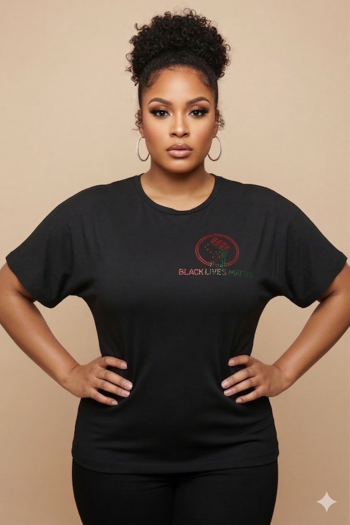 Women's black combed cotton t-shirt with "BLACK LIVES MATTER" and a raised fist in red and green rhinestones.