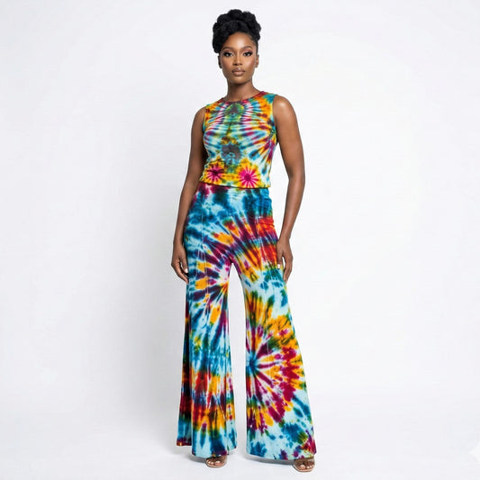 Woman wearing a colorful tie-dye top and pants on a white background