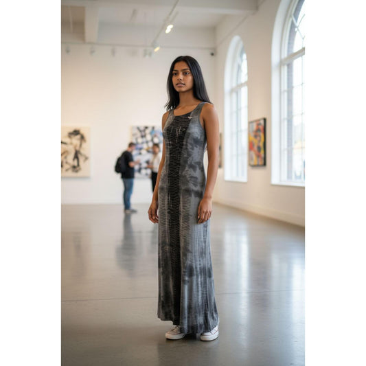 Woman wearing a long, tie dye dress standing in an art gallery.