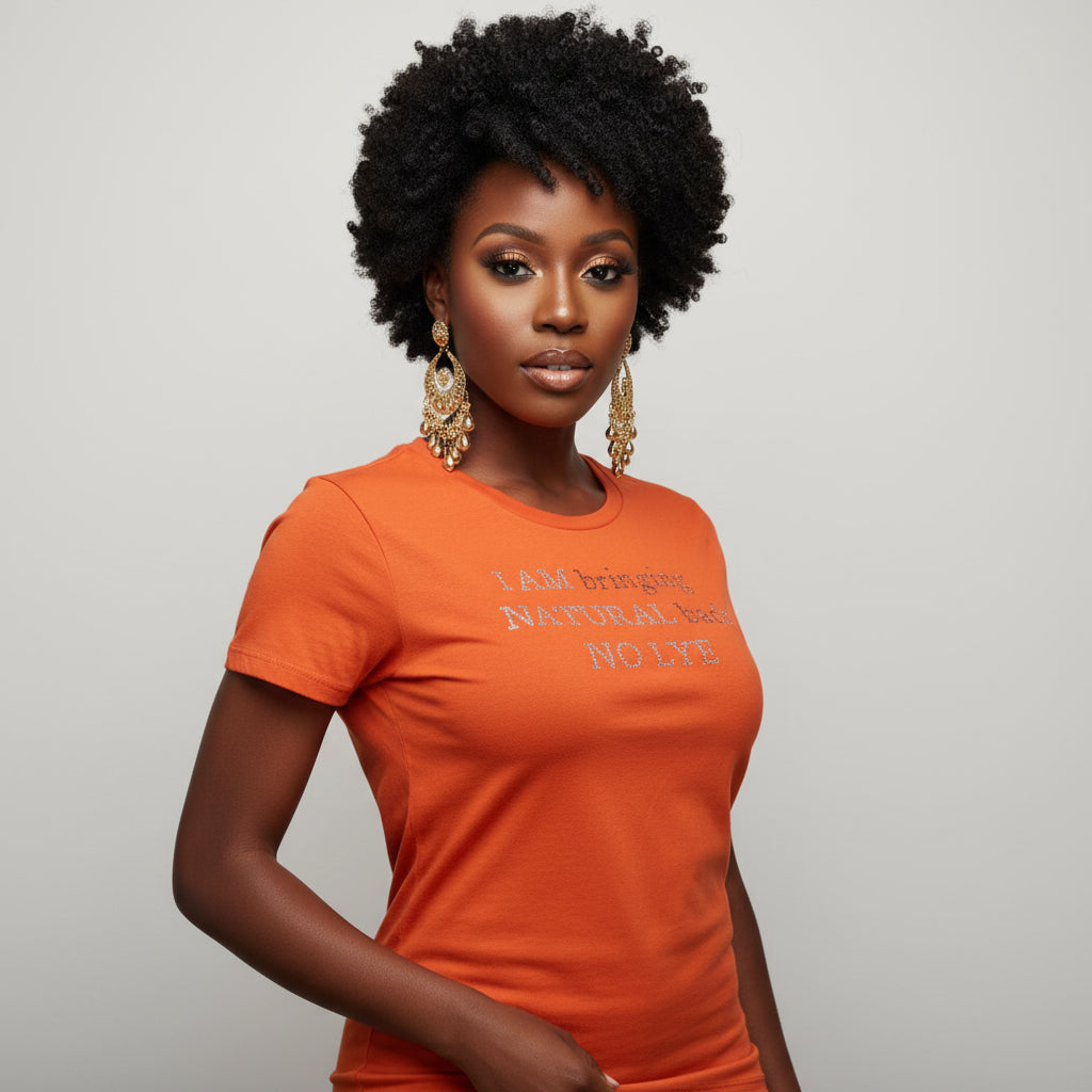 Woman in natural hair with an orange fitted t-shirt "I AM bringing NATURAL back NO LYE" rhinestones.