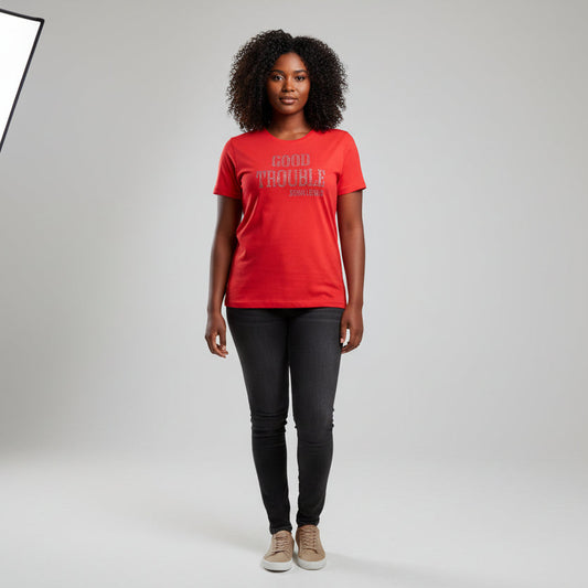 Woman wearing a red "Good Trouble" rhinestone t-shirt with black jeans and tan sneakers.