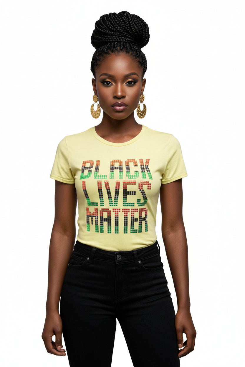 Woman in a yellow BLM t-shirt with red, black, and green metallic squares, black jeans.