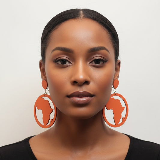Woman wearing large, round orange wooden earrings with cut-out Africa map silhouettes.