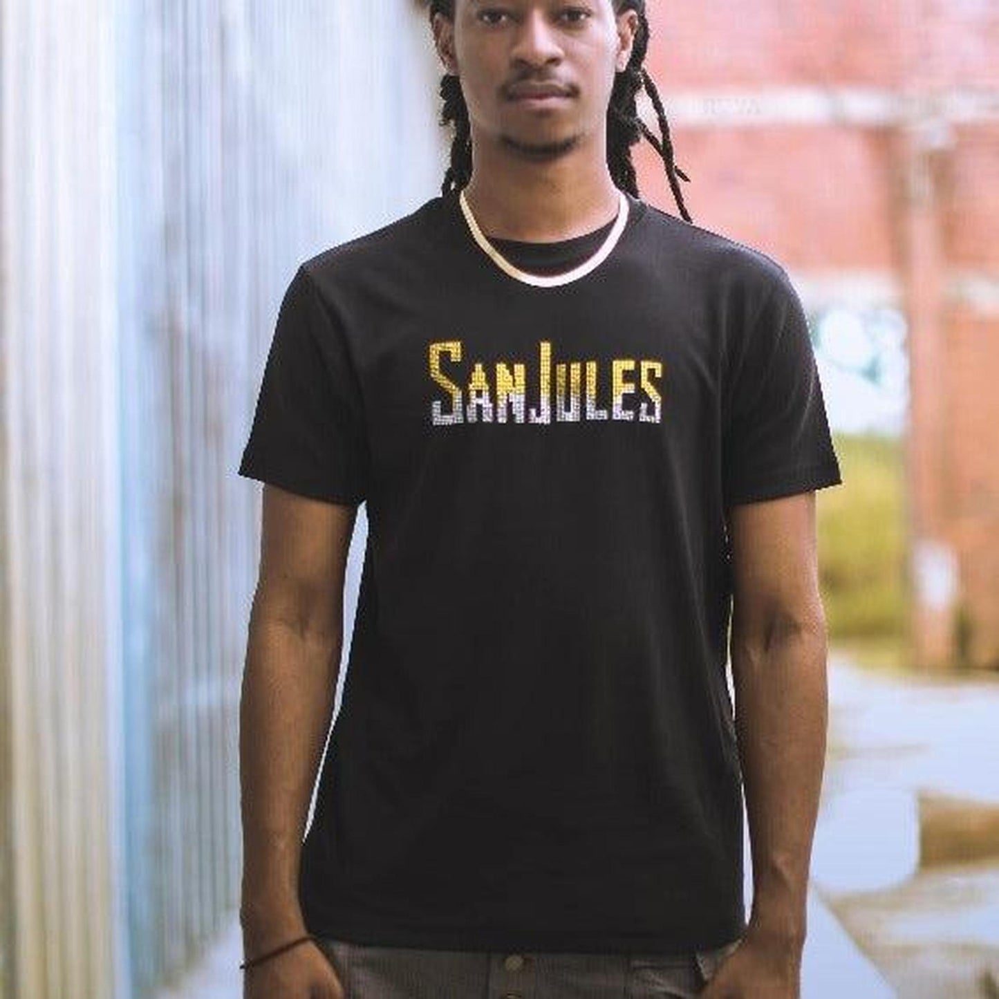 Black combed cotton Signature T-shirt with "Sanjules" in gold and silver rhinestone design.