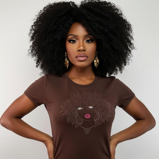 Woman in brown t-shirt with rhinestone and pearl lip design, gold earrings, and natural curly hair.