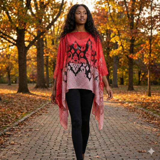 Woman walking on a path in an autumn park wearing a red and black patterned schawl