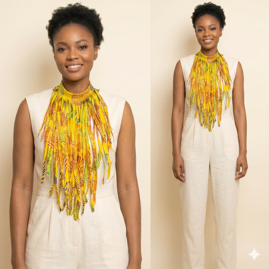 Woman wearing a yellow and green patterned scarf with a plain background