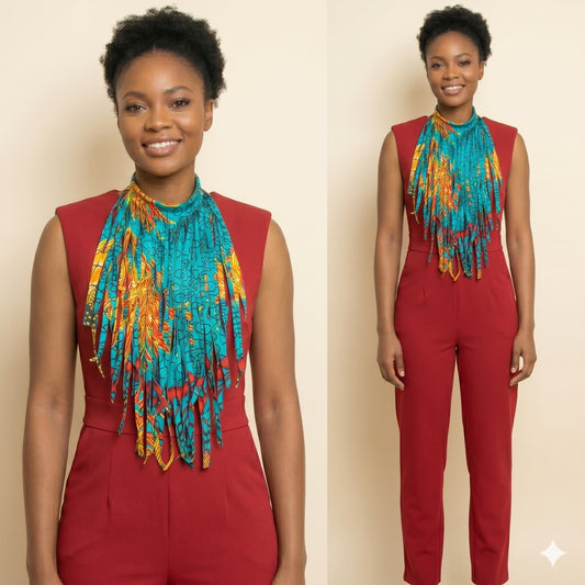 Woman wearing a red jumpsuit and colorful scarf against a beige background