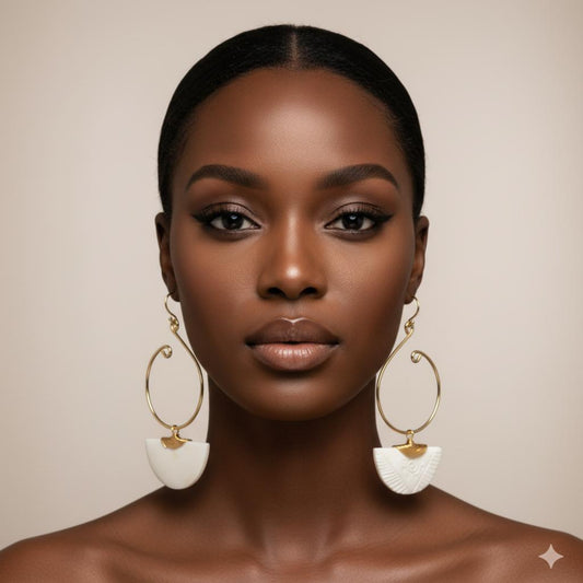 Kenyan brass, and hand-carved bone drop earrings on a model.