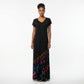 A woman modeling a black maxi dress with a V-neck and short sleeves, featuring a colorful tiedye