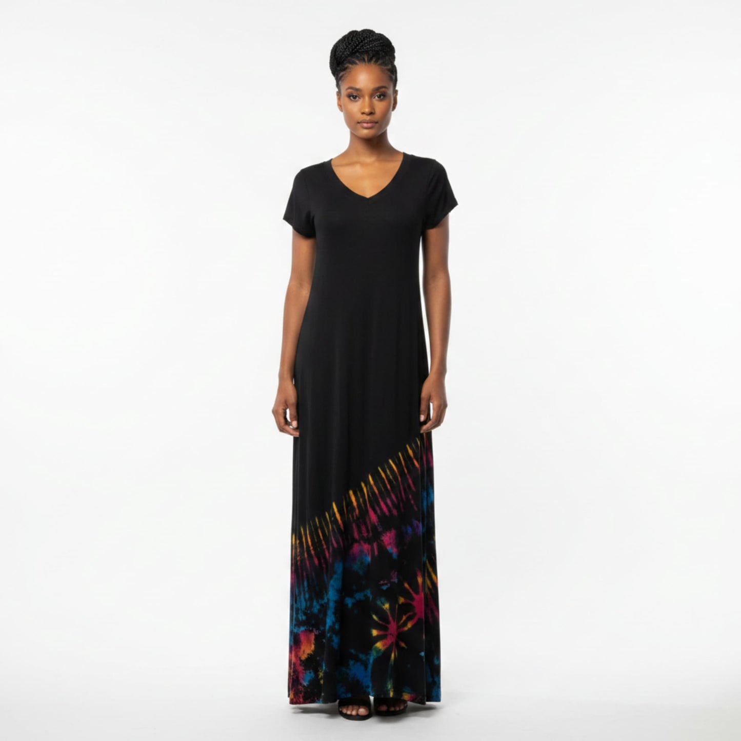 A woman modeling a black maxi dress with a V-neck and short sleeves, featuring a colorful tiedye