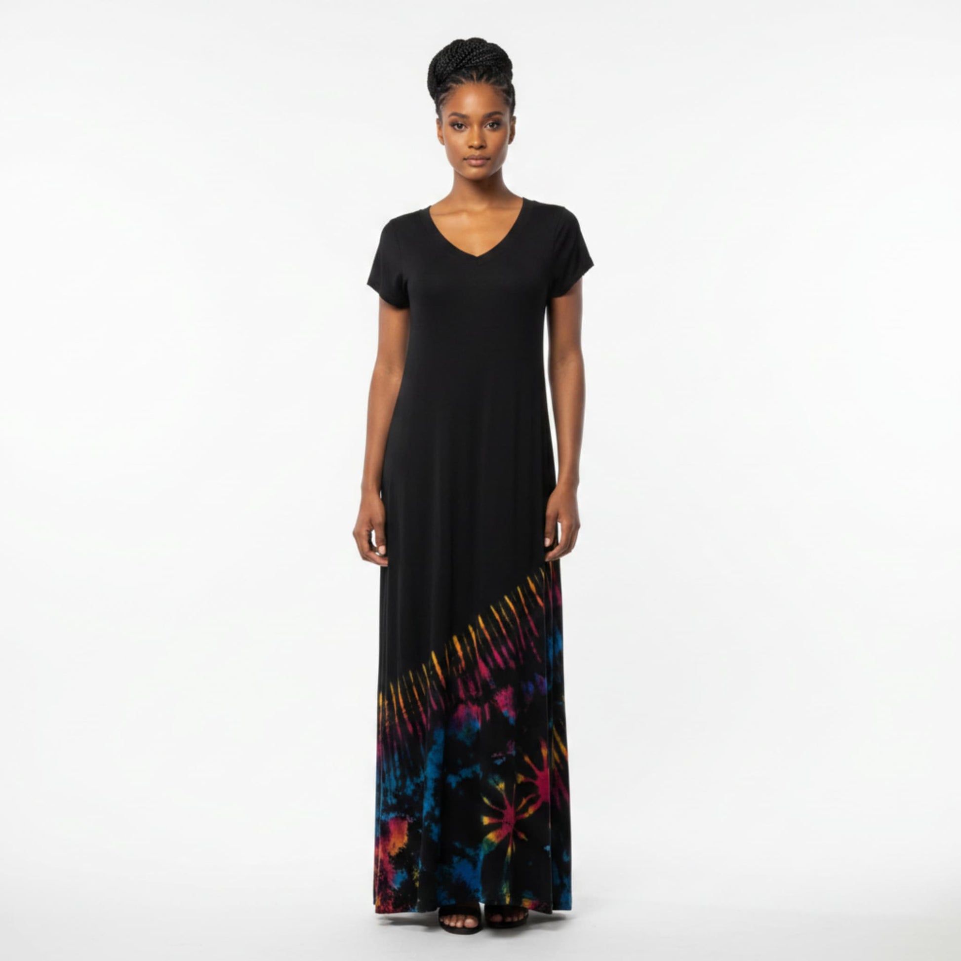 A woman modeling a black maxi dress with a V-neck and short sleeves, featuring a colorful tiedye