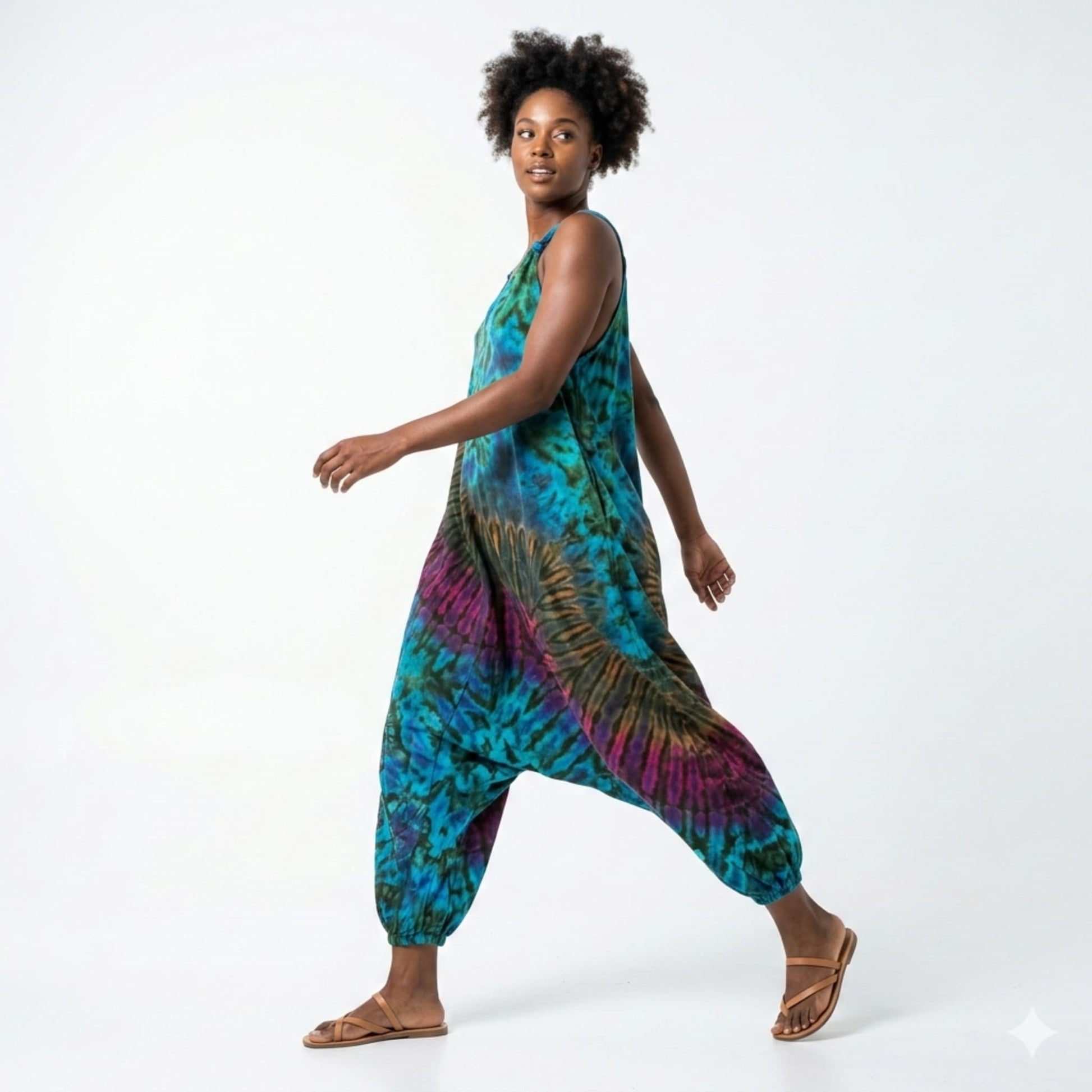Person wearing a tie-dye harem jumpsuit on a white background SanJules