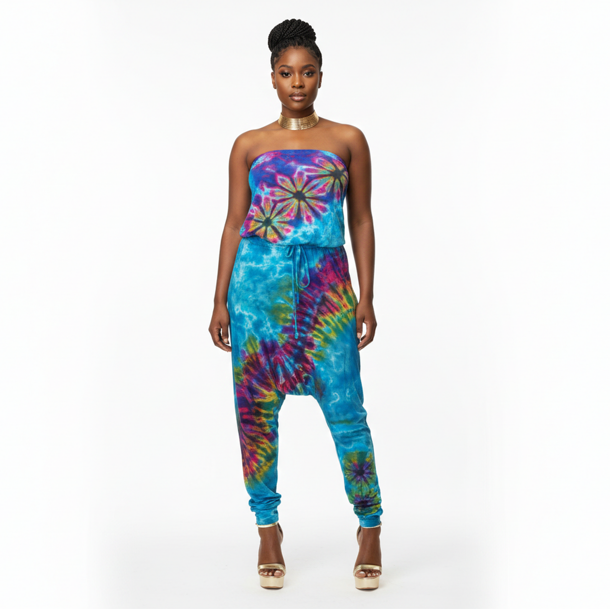 Woman wearing a colorful tie-dye jumpsuit on a white background