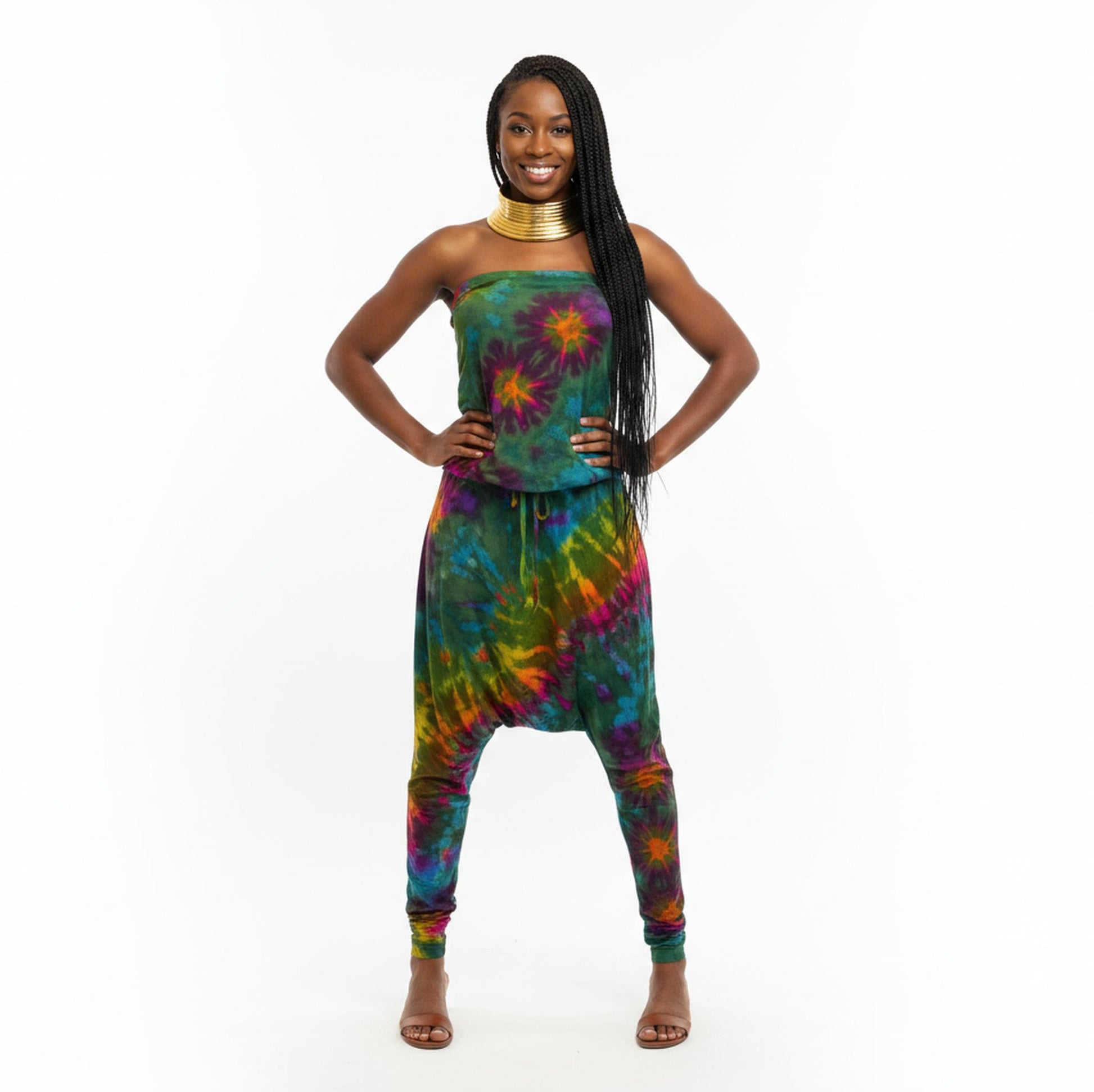 Woman wearing a colorful tie-dye jumpsuit on a white background