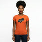 Woman in an orange t-shirt with a black rhinestone and metallic film design.