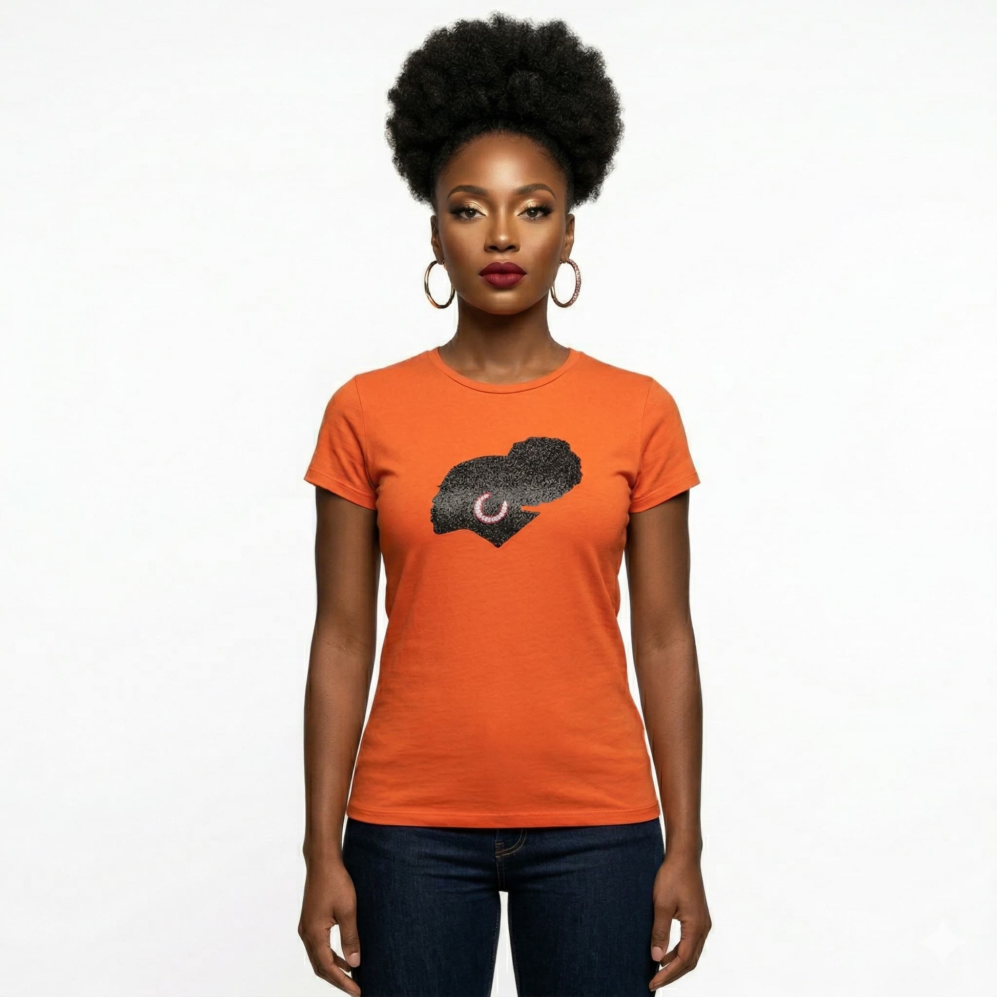 Woman in an orange t-shirt with a black rhinestone and metallic film design.