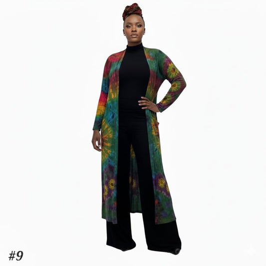 Person wearing a colorful tie-dye cardigan over a black outfit on a white background-Sanjules