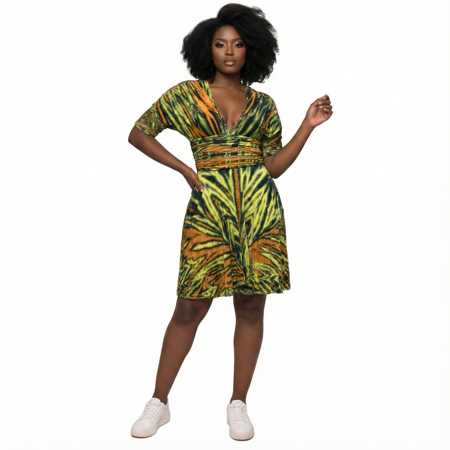 Woman wearing a green and orange patterned dress on a white background