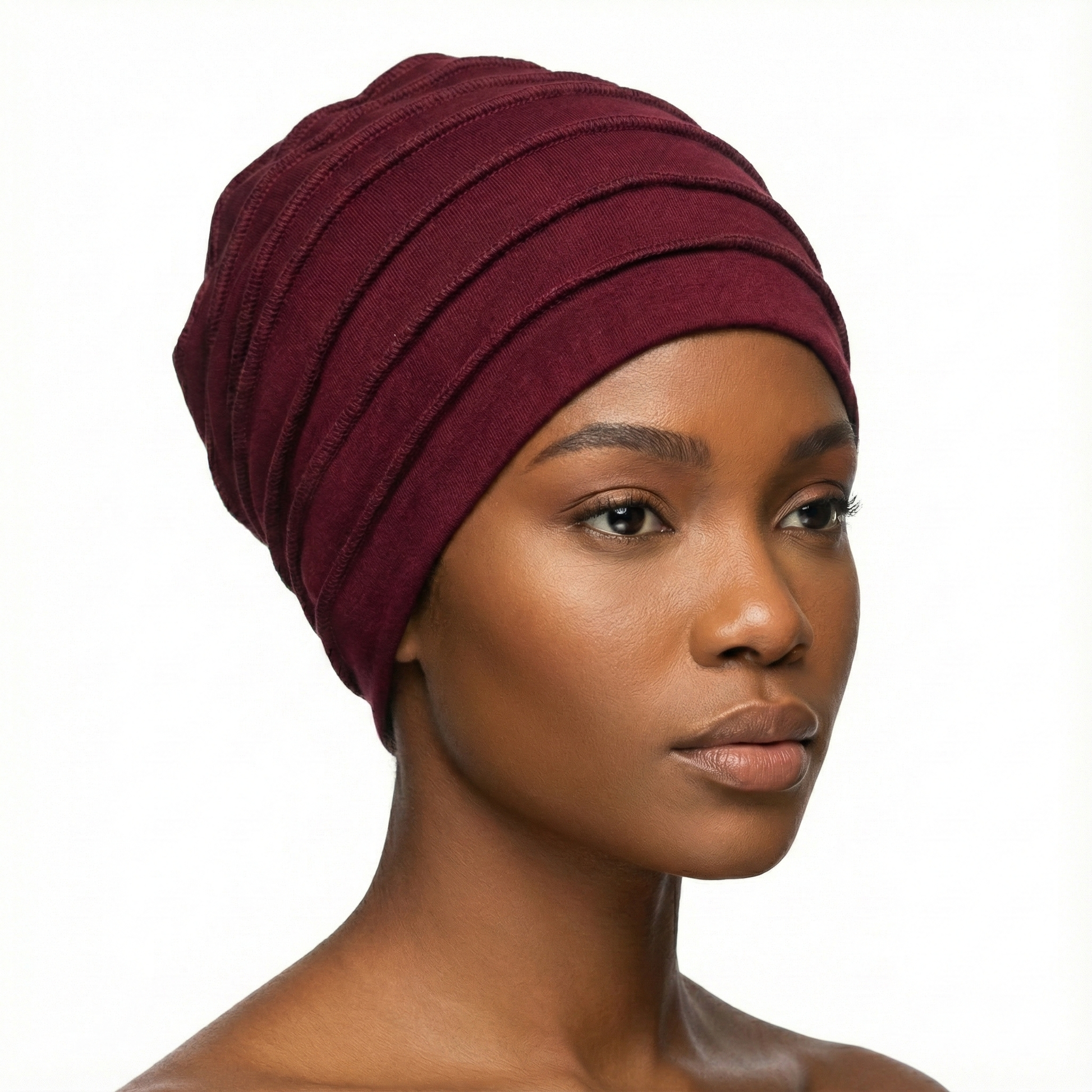 Woman wearing a burgundy hat on a white background