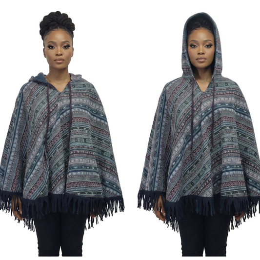 Woman wearing a patterned hooded poncho with fringes on a white background