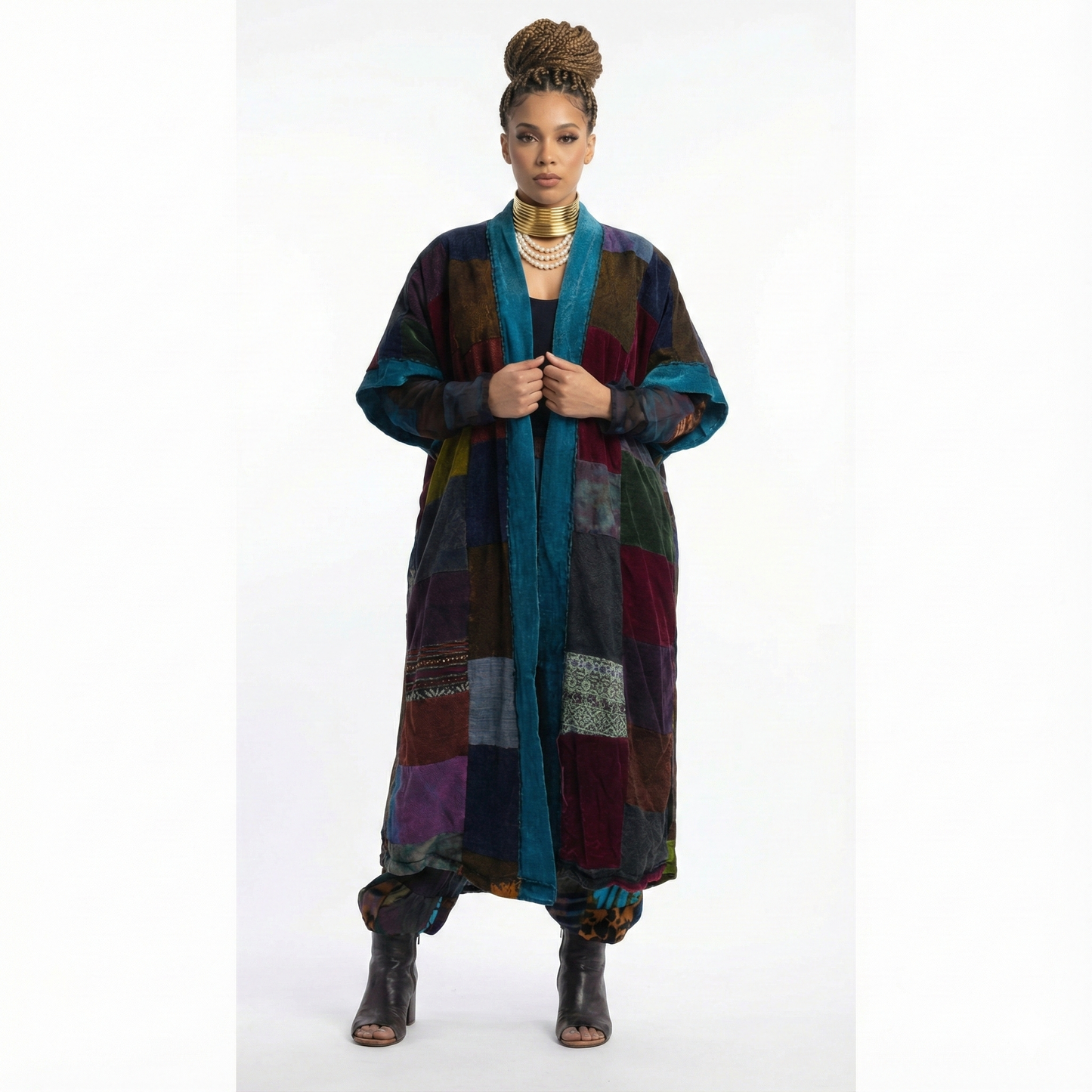 Woman wearing a colorful patchwork coat on a white background