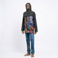 Person wearing a black hooded jacket with a colorful patchwork design on a white background