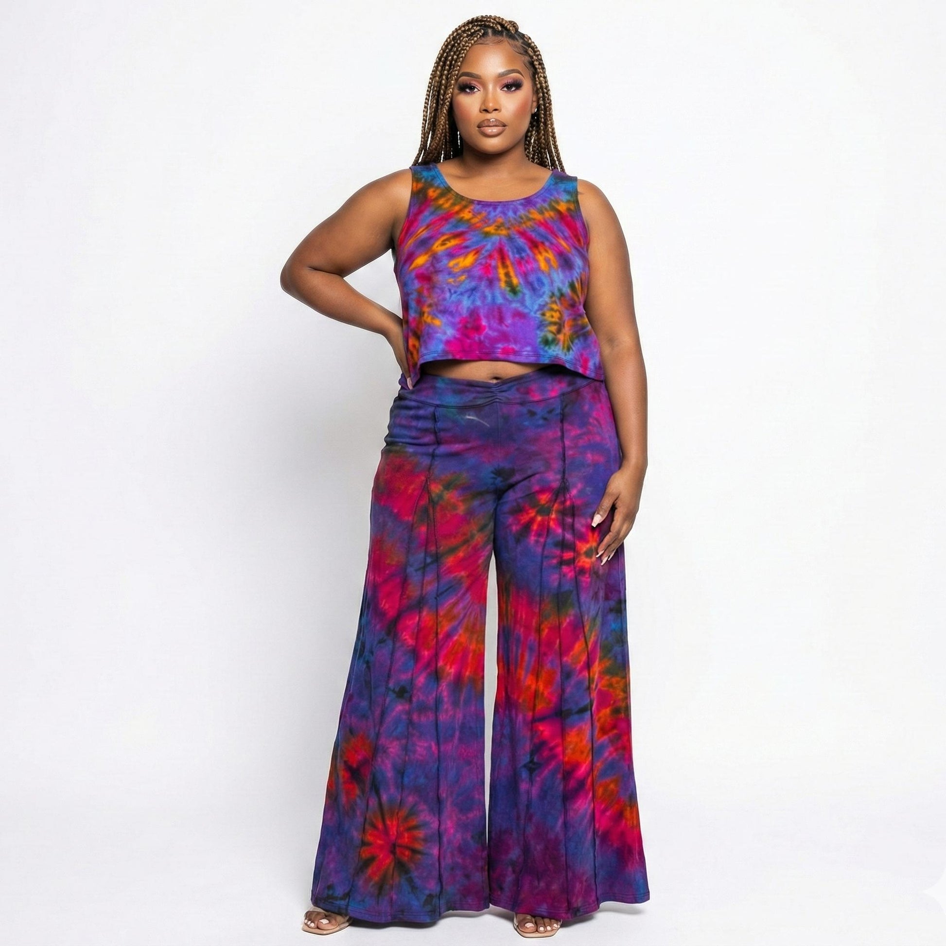 Woman wearing a colorful tie-dye outfit on a white background
