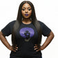 Woman wearing a black t-shirt with a royal blue rhinestone afro design and reflective film.