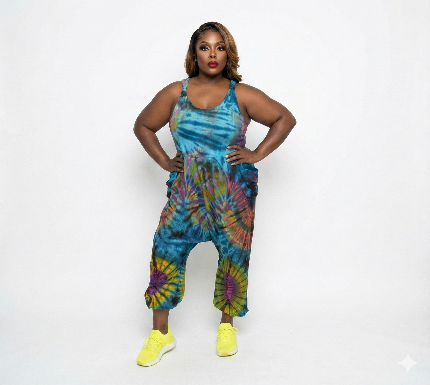 Woman wearing a tie-dye jumpsuit on a white background