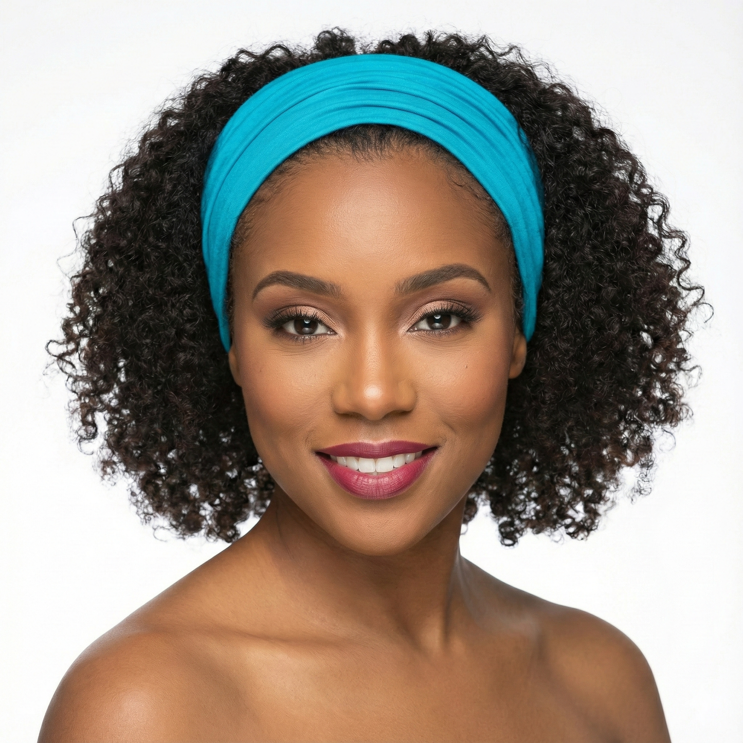 Woman wearing a blue headband against a white background