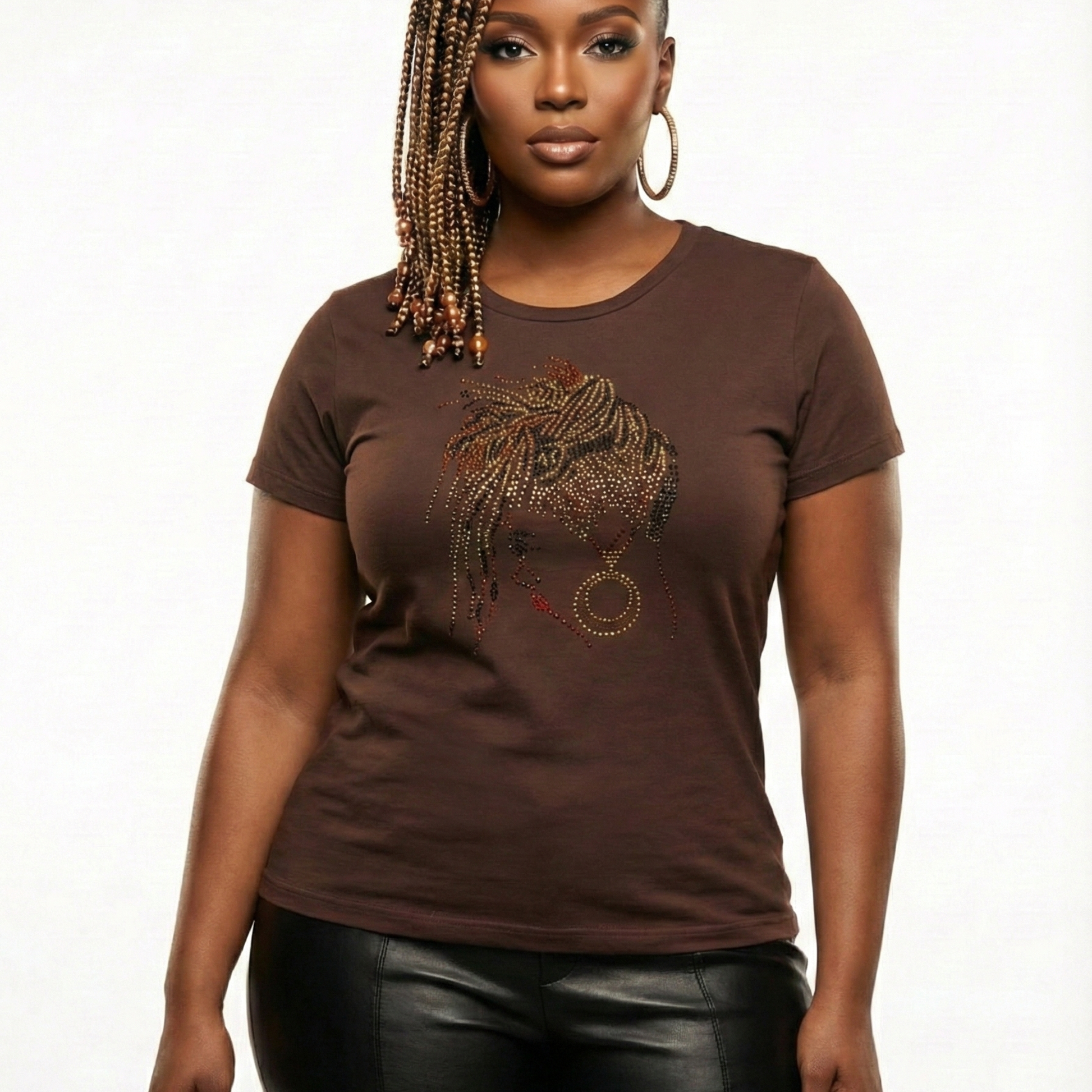 Woman in a brown Loc Dreams t-shirt with a rhinestone loc design, paired with black faux pants.