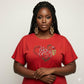 Woman in a red "I Love Chocolate" rhinestone t-shirt with pearl oval stones and reflective film.