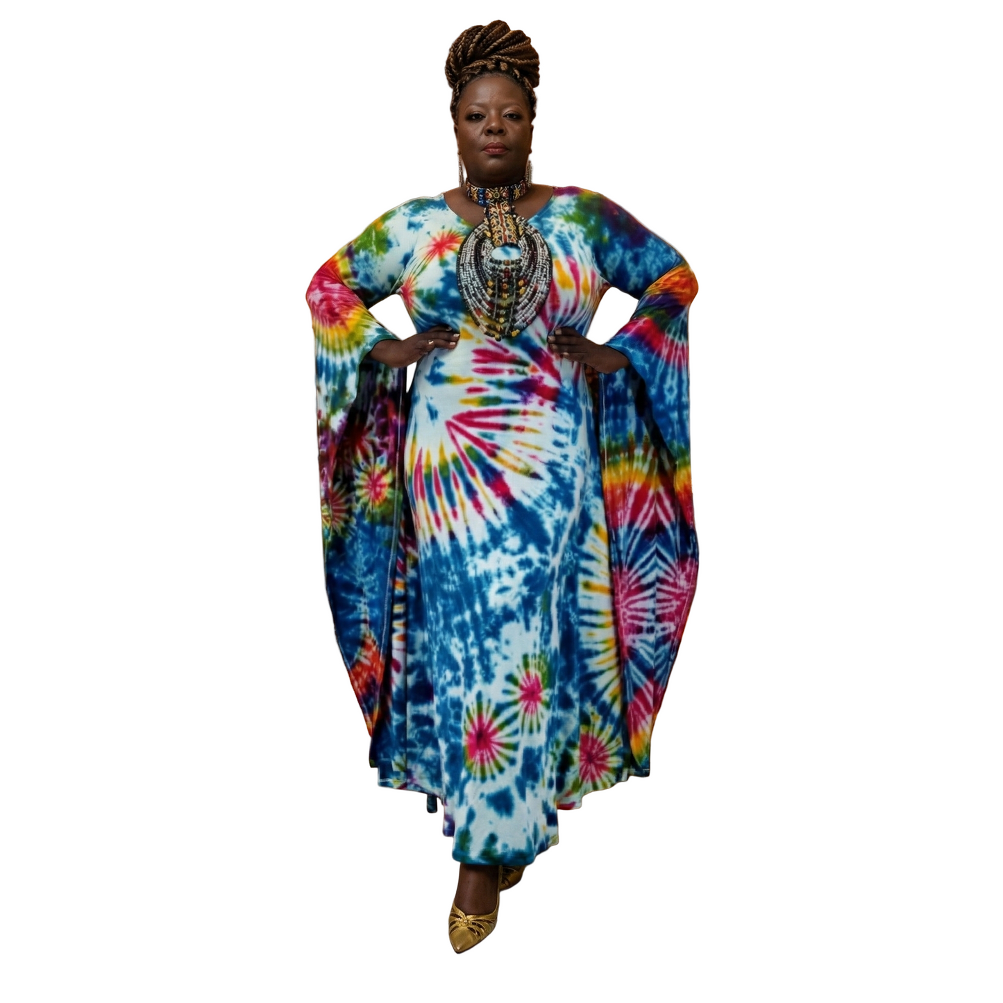 Woman in a colorful tie-dye dress standing in an elegant dining room .