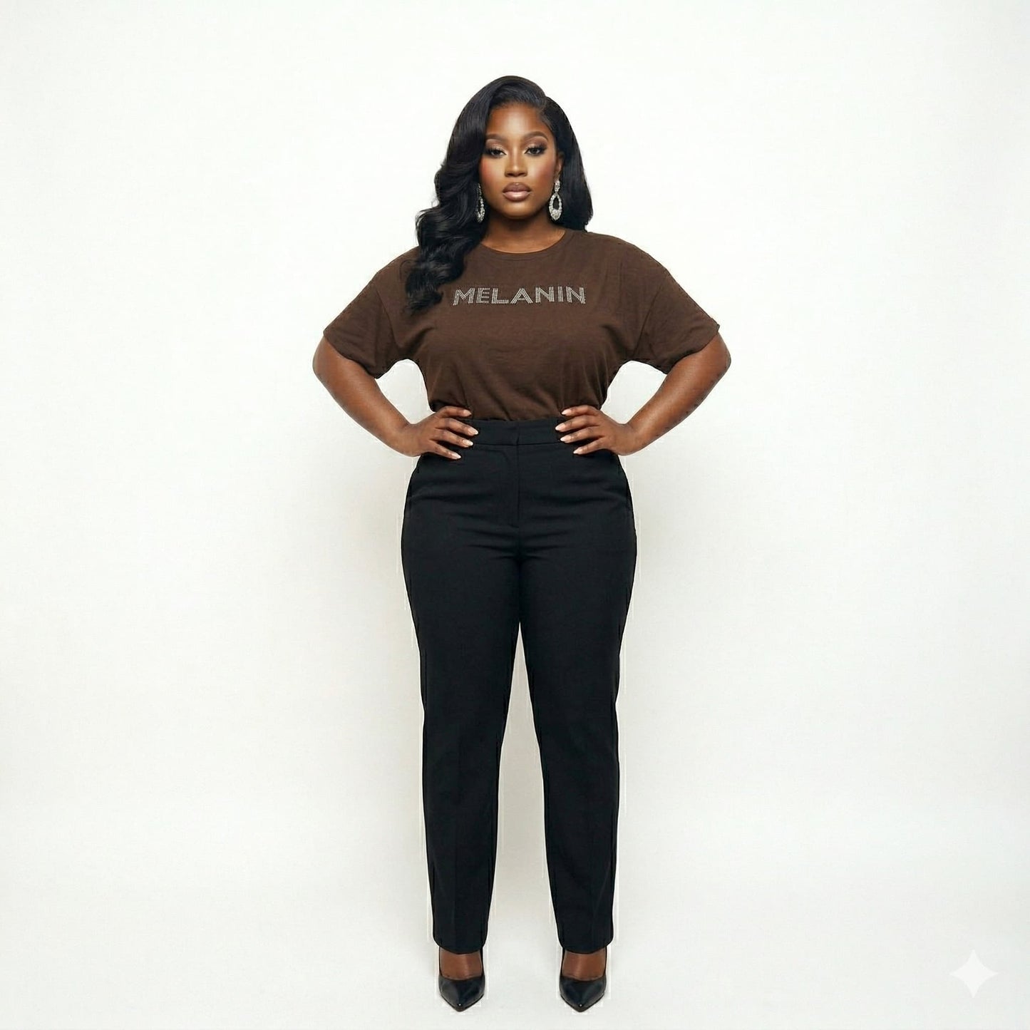 Woman in a brown "MELANIN" t-shirt and black pants, celebrating Black pride and beauty.