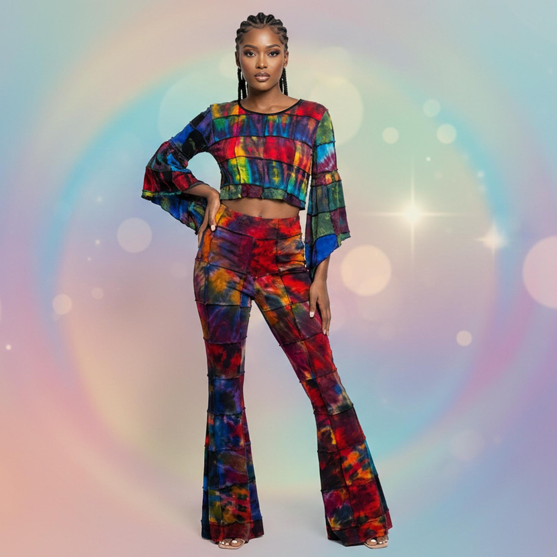 Woman wearing a colorful tie-dye top and bottom on a white background