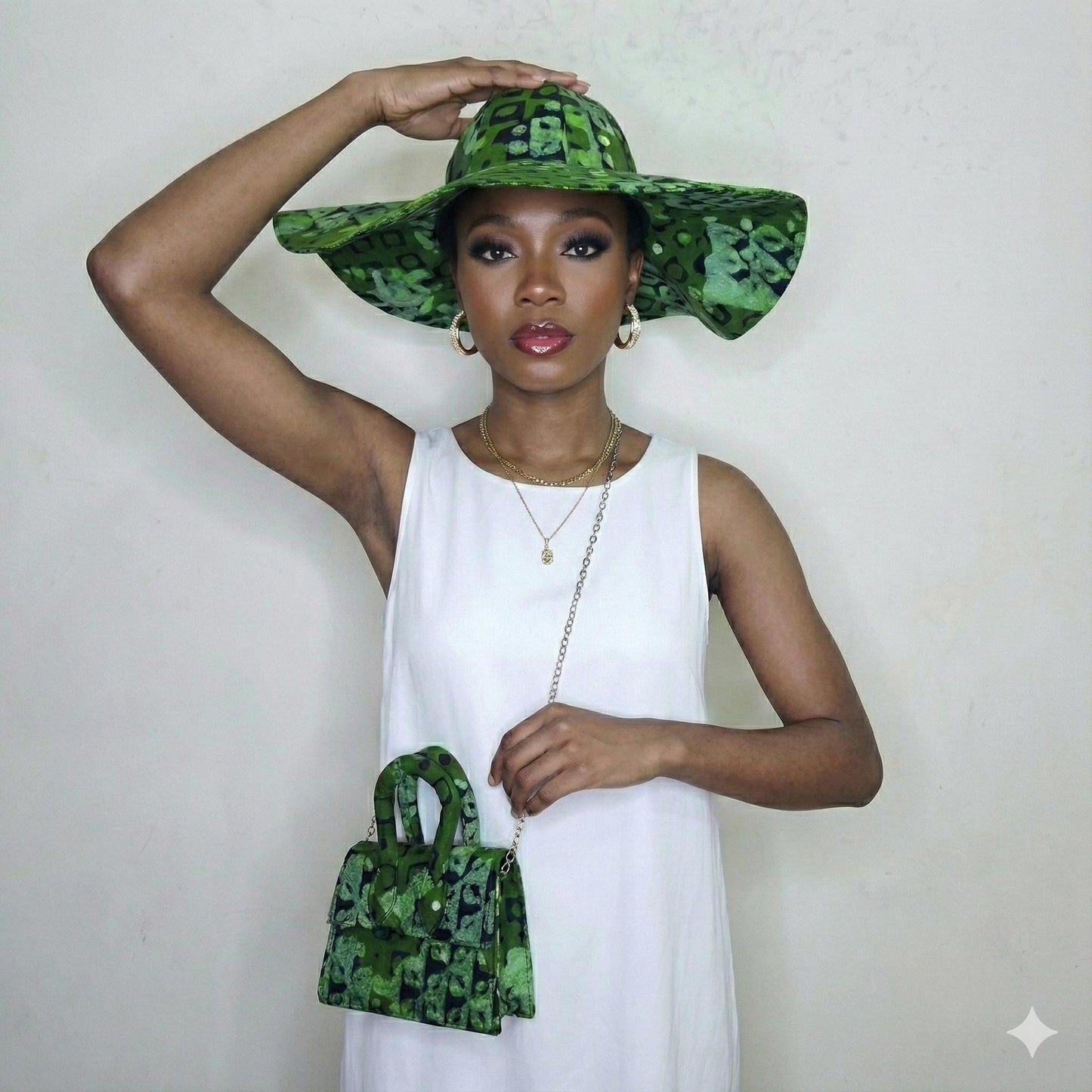 Woman wearing a green camouflage hat and holding a matching handbag against a white background