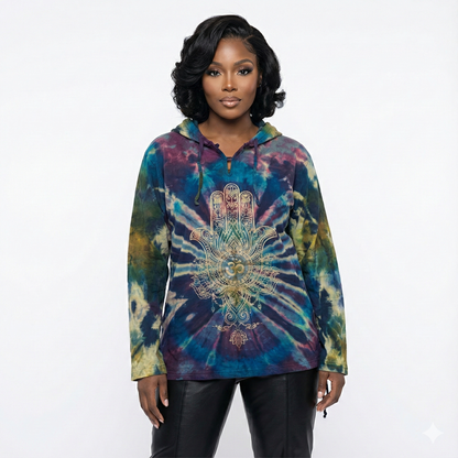 Woman wearing a tie-dye hoodie with a Hamsa hand design on a white background