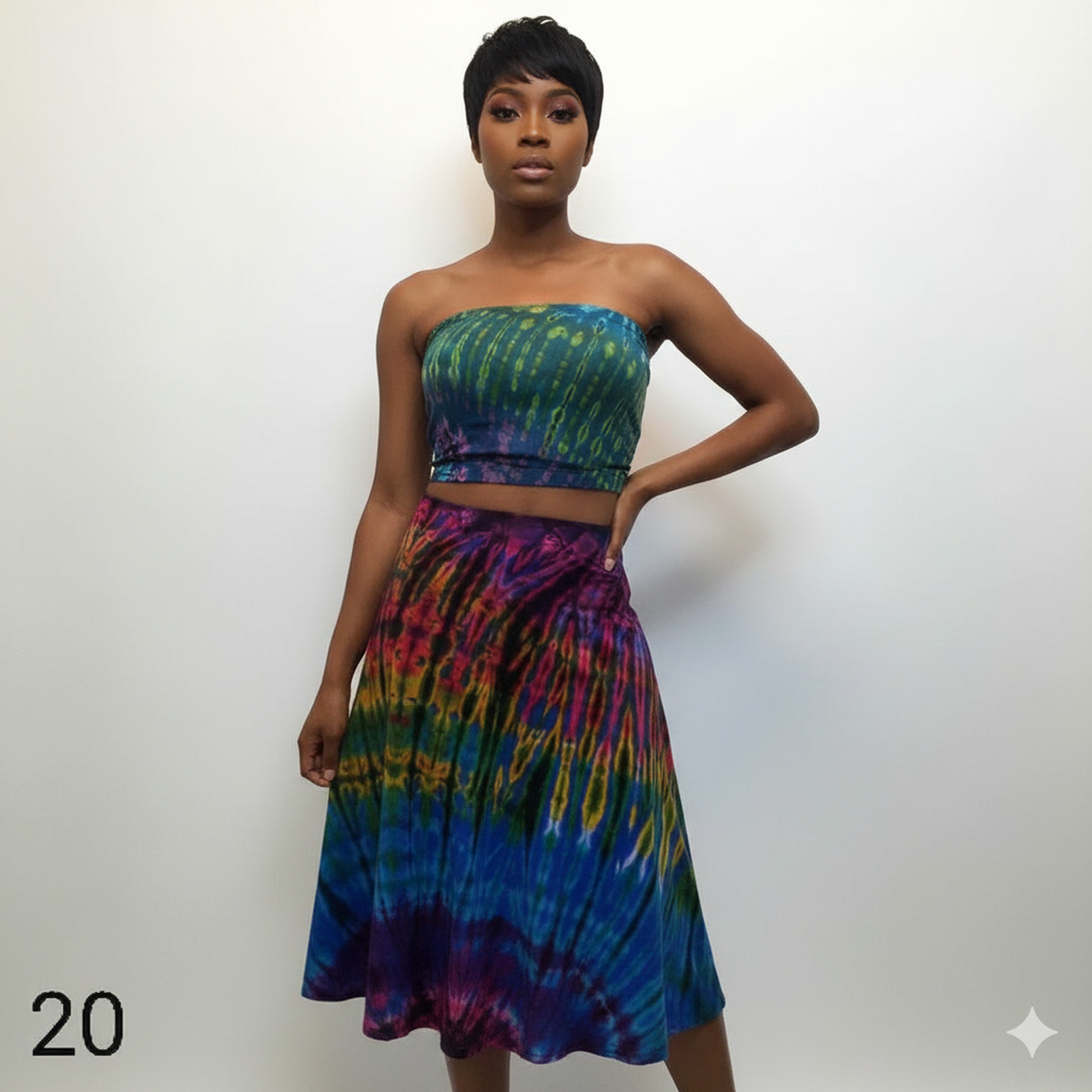 Woman wearing a colorful tie-dye tube top against a white background