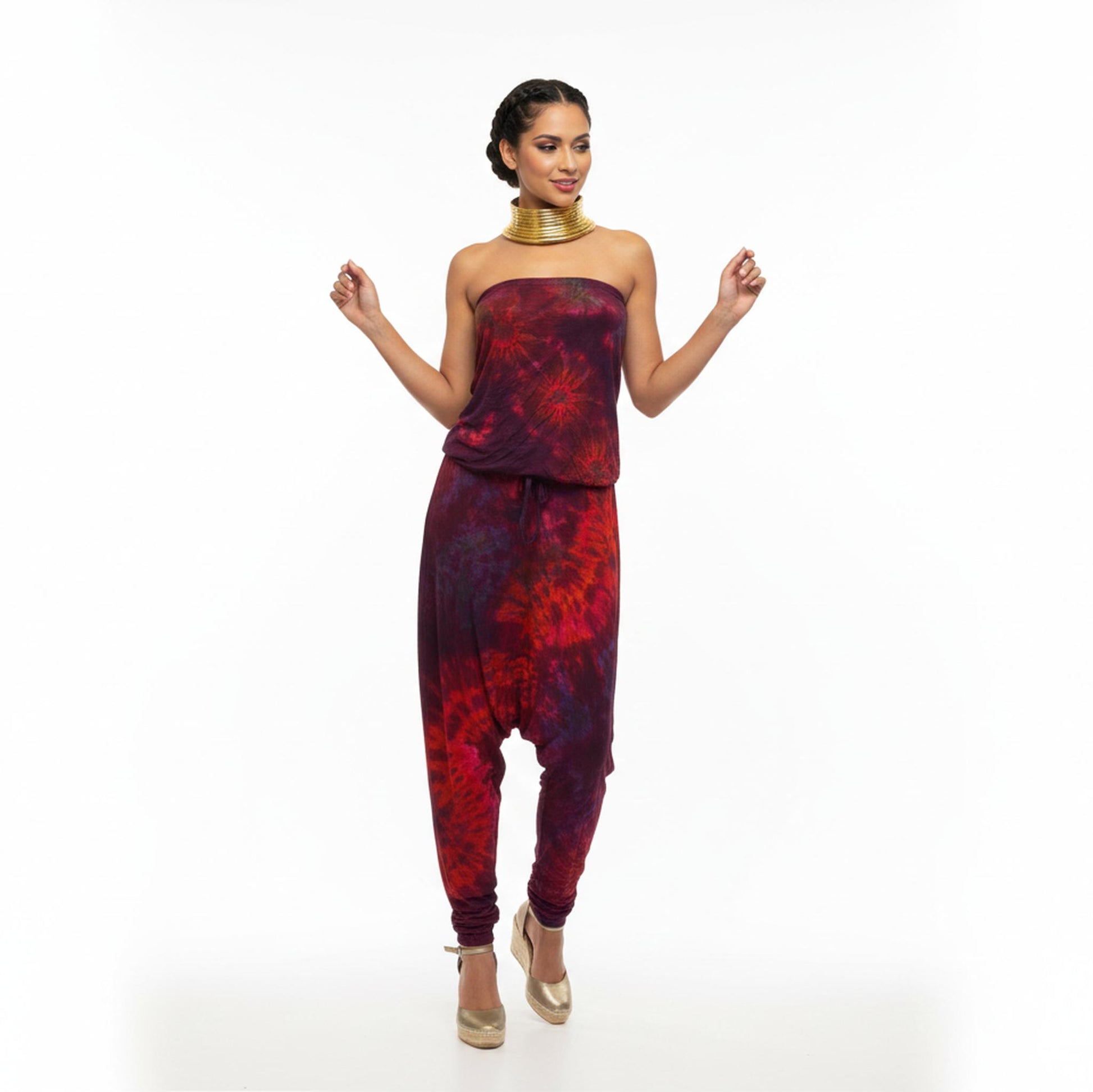 Woman wearing a red and purple tie-dye outfit on a white background