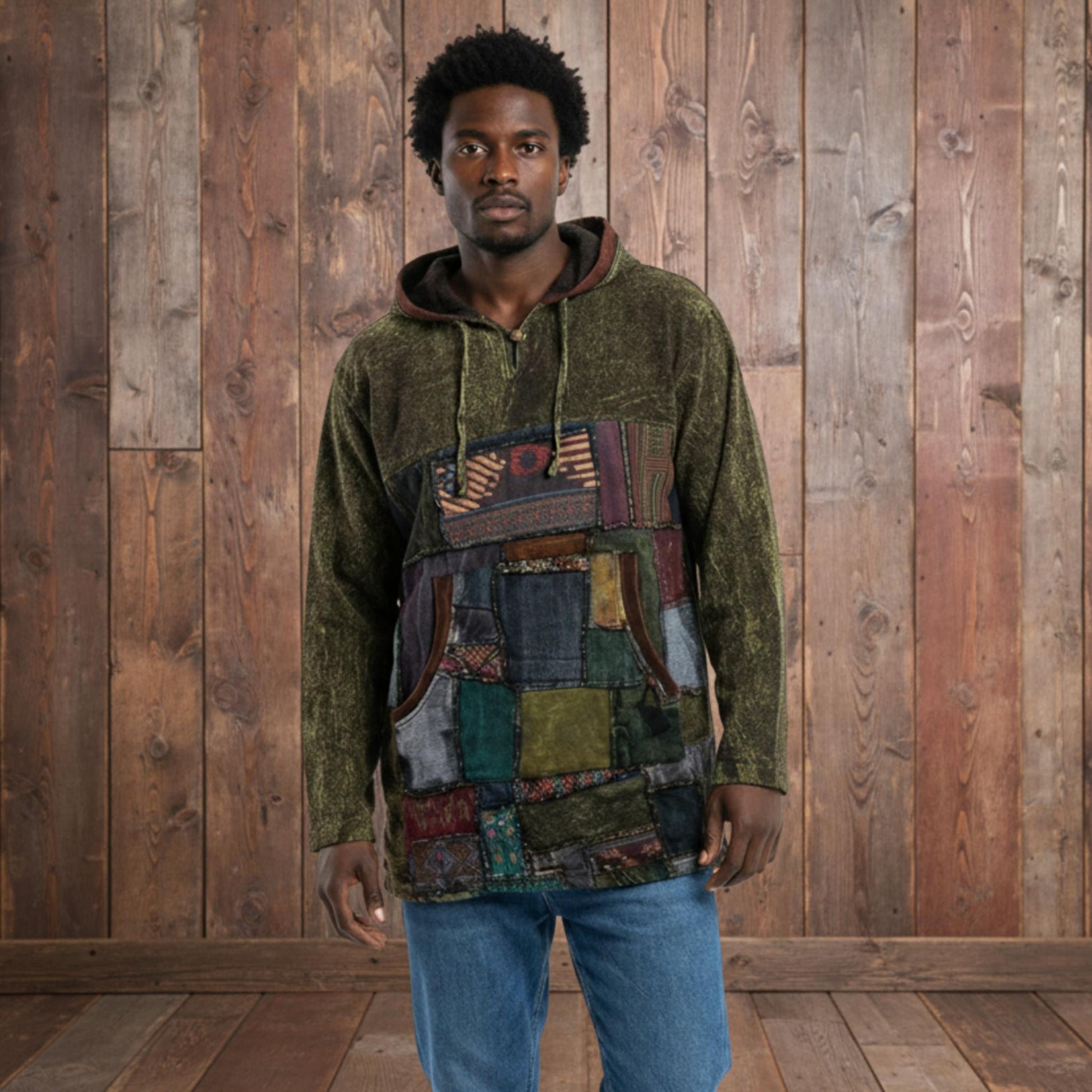 Man wearing a patchwork hoodie with a plain background