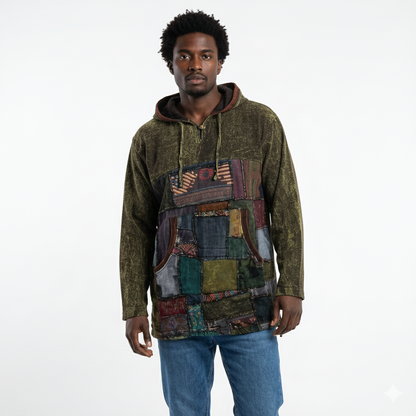Man wearing a patchwork hoodie with a plain background