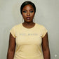 Woman wearing a yellow combed cotton "MELANIN" t-shirt with rhinestone lettering, celebrating Black pride.