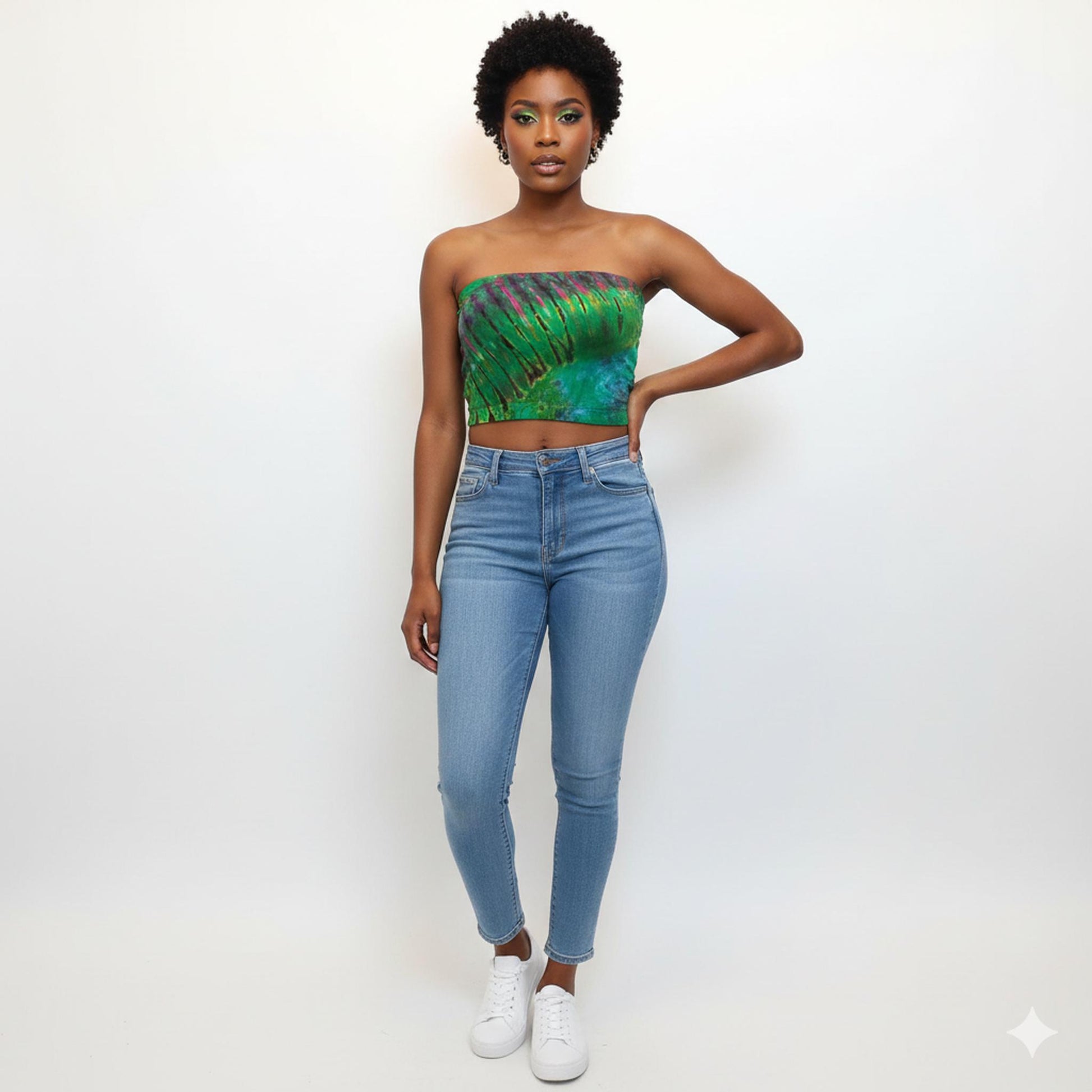 Woman wearing a green tube top and blue jeans on a white background
