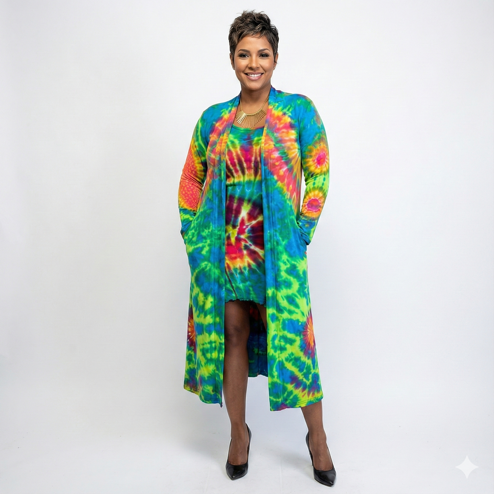 Woman wearing a colorful tie-dye dress with a matching cardigan on a white background