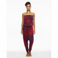 Woman wearing a red and purple tie-dye jumpsuit on a white background
