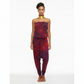 Woman wearing a red and purple tie-dye jumpsuit on a white background